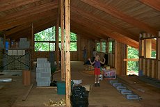 The roof is on and the Rumford fireplace is under construction...