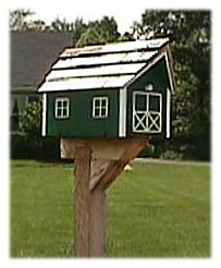 A barn style wooden mailbox