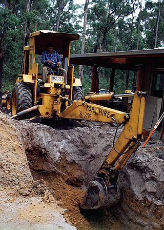 Digging holes for septic tanks...no deep sewerage in the forest.