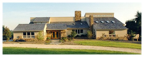 Contemporary home with cedar siding, dry stack stone, and cedar shakes on the roof