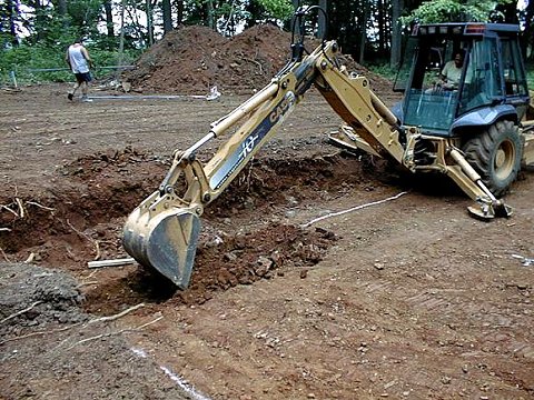 Backhoe digging footings