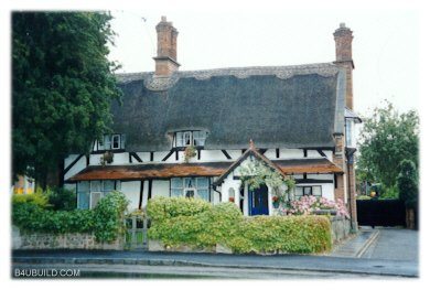 Thatched roof Tudor style English cottage