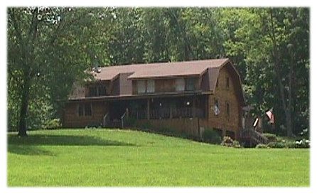 Log home with a gambrel roof and shed dormers