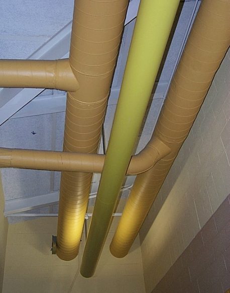 Exposed high pressure spiral ductwork, plumbing pipes, and electrical conduits