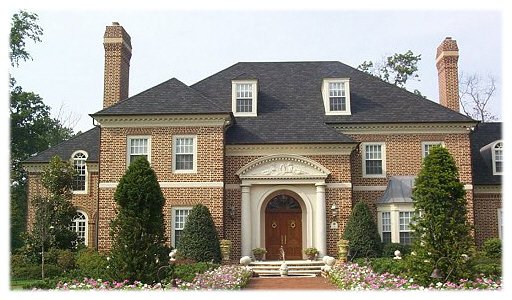 A luxury custom home with a fountain in front