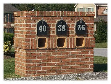 A group of three custom brick mailboxes