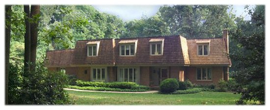 A picture of a house with a mansard roof