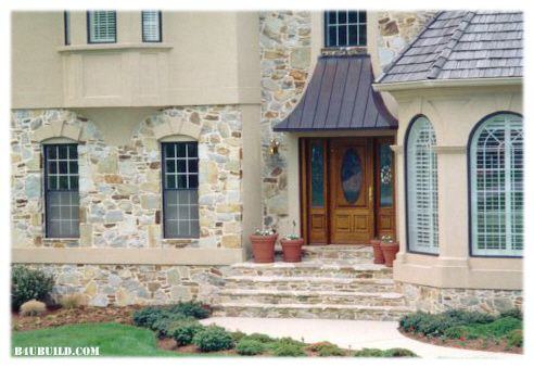 Stone, "Dryvit", and cedar shingles